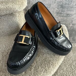 Tod's Shiny Black Loafers with Gold Detail
